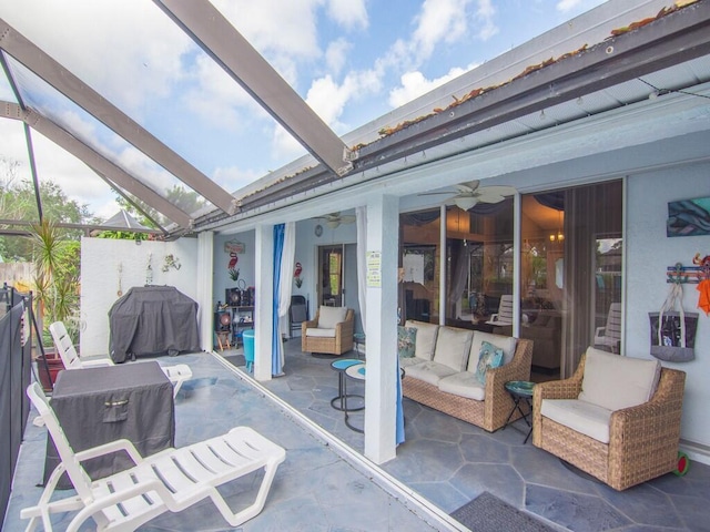 view of patio featuring grilling area, fence, ceiling fan, and outdoor lounge area
