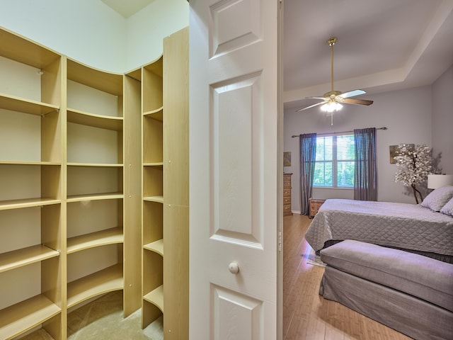 bedroom with a ceiling fan and wood finished floors