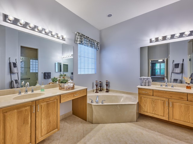 full bath featuring tile patterned flooring, a sink, a bath, and two vanities