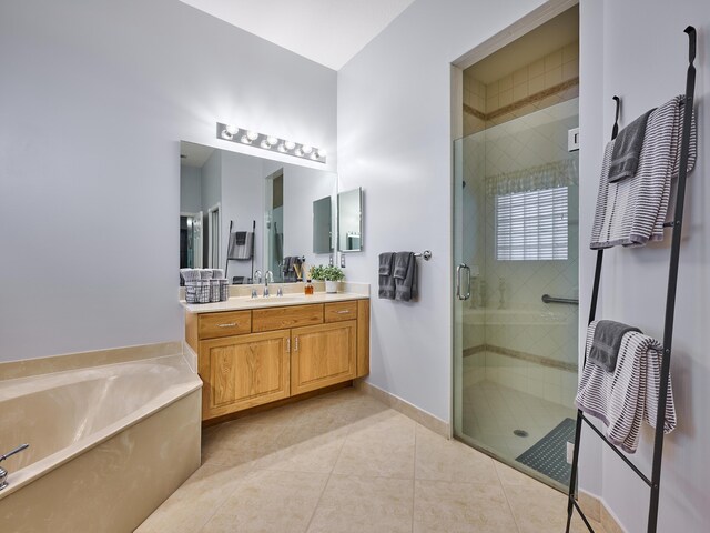 bathroom with tile patterned floors, a shower stall, a bath, and vanity