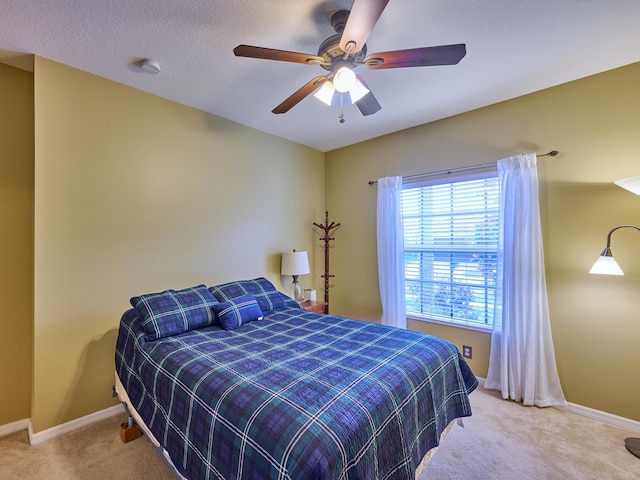 bedroom featuring baseboards, ceiling fan, and carpet flooring