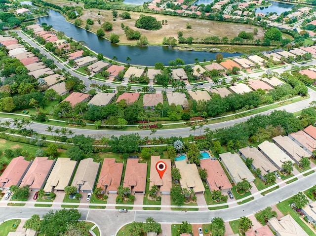 birds eye view of property featuring a water view and a residential view