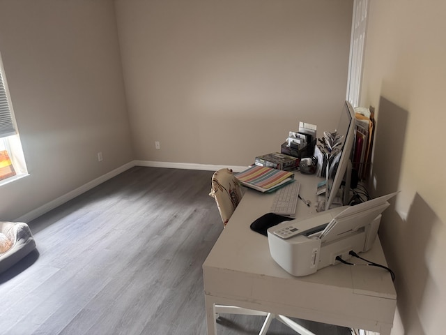 office area with baseboards and wood finished floors
