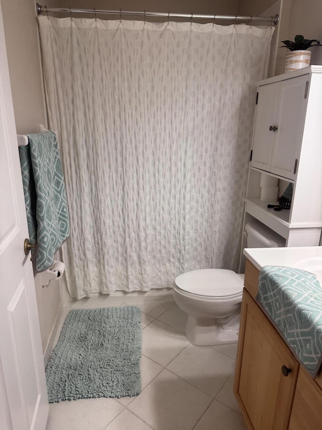 bathroom with toilet, a shower with curtain, tile patterned flooring, and vanity
