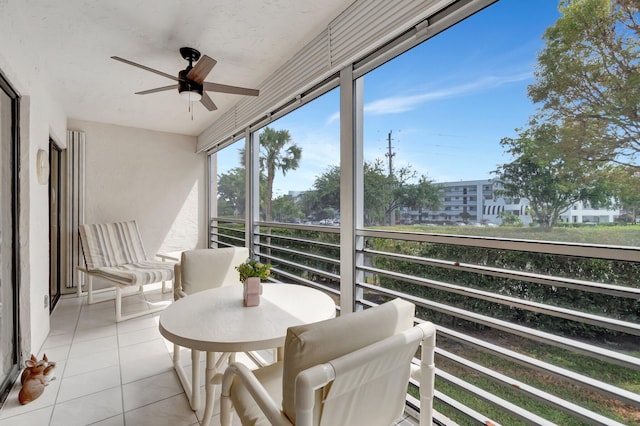 sunroom / solarium featuring ceiling fan and plenty of natural light