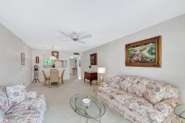 living area featuring visible vents, ceiling fan, and light colored carpet
