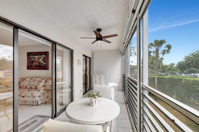 sunroom / solarium featuring ceiling fan