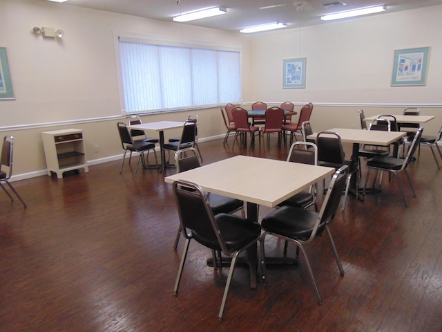 dining room featuring baseboards and dark wood finished floors