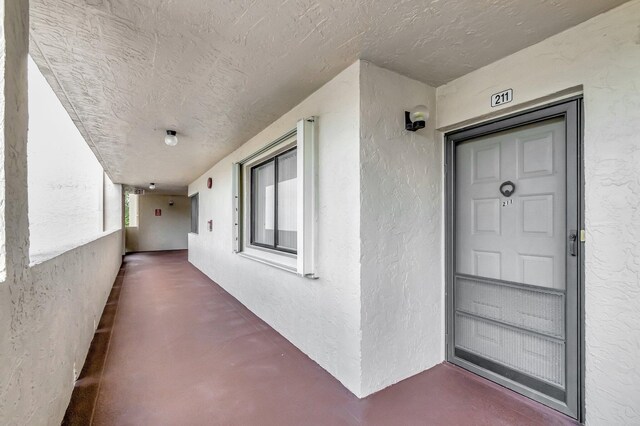 view of exterior entry with stucco siding