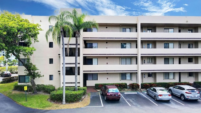 view of building exterior featuring uncovered parking