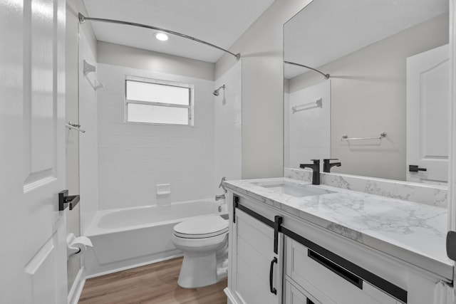 bathroom featuring wood finished floors, toilet, shower / tub combination, vanity, and recessed lighting