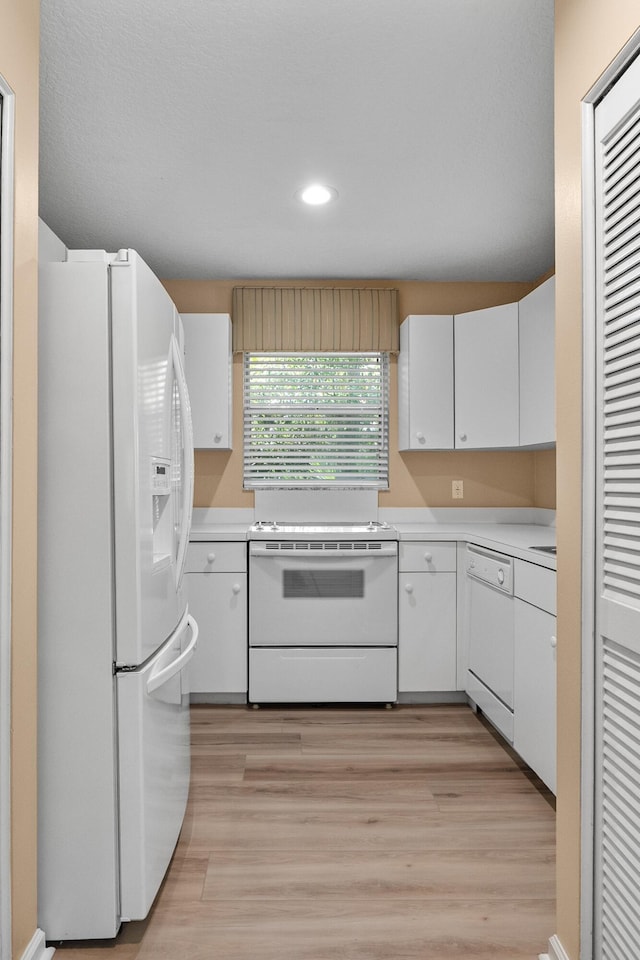 8623 159th Ct N, Palm Beach Gardens, FL 33418 - kitchen with white appliances, light countertops, white cabinetry, recessed lighting, and light wood finished floors