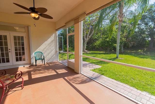 unfurnished sunroom with ceiling fan and french doors