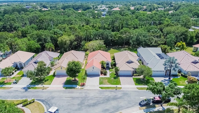 bird's eye view featuring a view of trees and a residential view