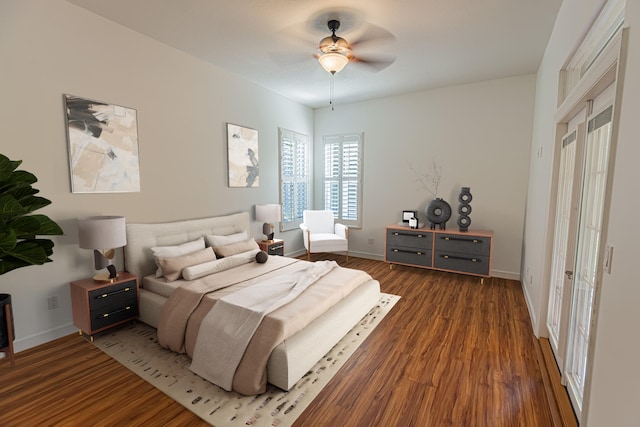 bedroom featuring baseboards, a ceiling fan, and wood finished floors