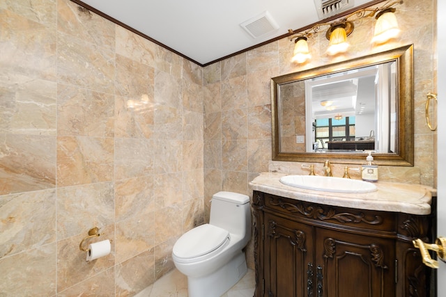 4740 S Ocean Blvd Unit 511, Highland Beach, FL 33487 - bathroom with visible vents, crown molding, vanity, toilet, and tile walls
