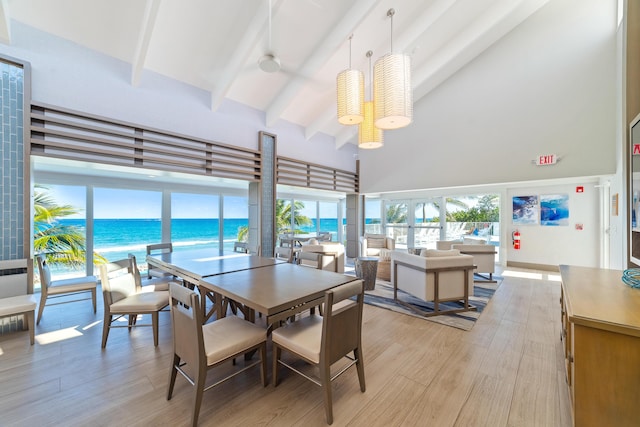 4740 S Ocean Blvd Unit 511, Highland Beach, FL 33487 - dining space featuring light wood-type flooring, a water view, beam ceiling, and high vaulted ceiling
