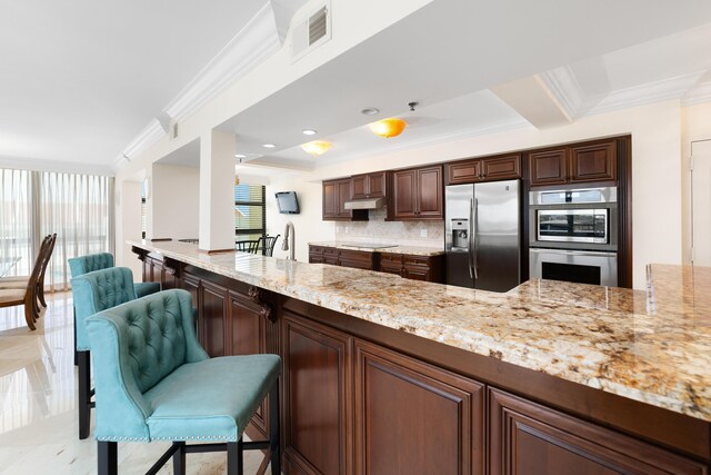 4740 S Ocean Blvd Unit 511, Highland Beach, FL 33487 - kitchen with a healthy amount of sunlight, tasteful backsplash, stainless steel appliances, and visible vents