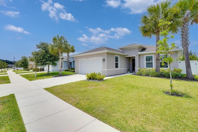 3625 Sapphire Hollow Way, Fort Pierce, FL 34981 - view of front facade with fence, a garage, stucco siding, concrete driveway, and a front lawn