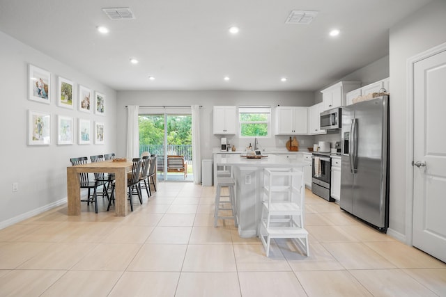 3625 Sapphire Hollow Way, Fort Pierce, FL 34981 - kitchen featuring recessed lighting, stainless steel appliances, a center island, visible vents, and light countertops