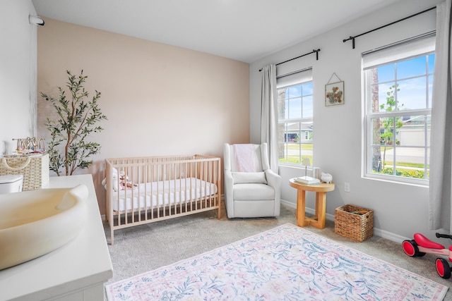 3625 Sapphire Hollow Way, Fort Pierce, FL 34981 - bedroom with baseboards, multiple windows, a nursery area, and carpet floors