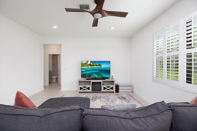 living area featuring a ceiling fan, visible vents, wood finished floors, baseboards, and recessed lighting