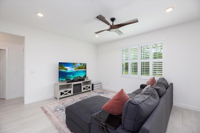 living room with baseboards, recessed lighting, ceiling fan, and wood finished floors