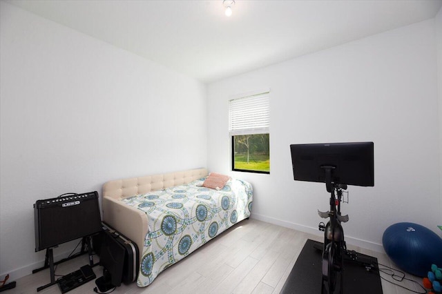 bedroom with baseboards and wood finished floors