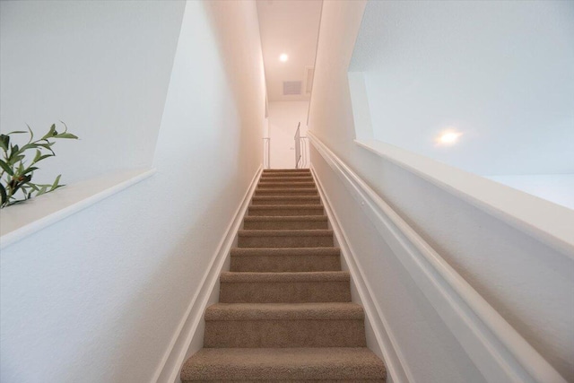 staircase featuring visible vents