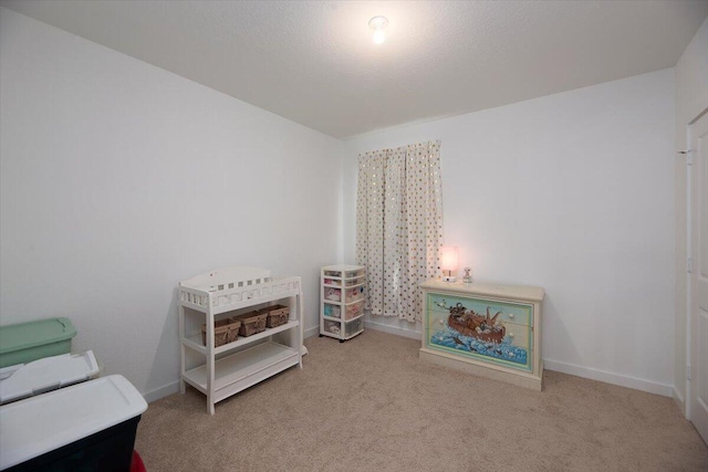bedroom with baseboards and carpet