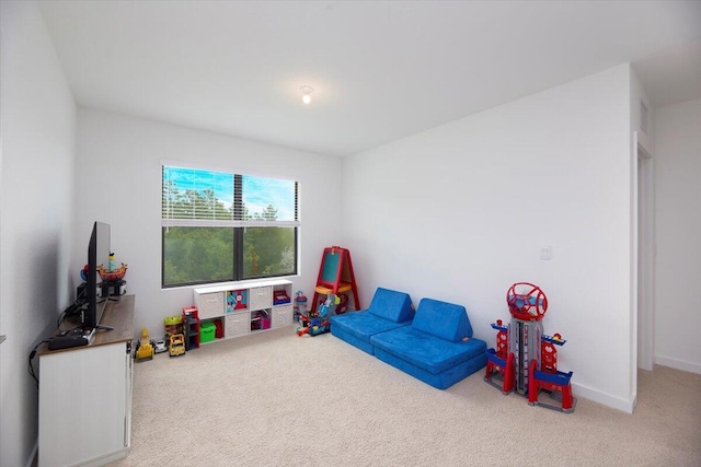 playroom featuring carpet floors and baseboards