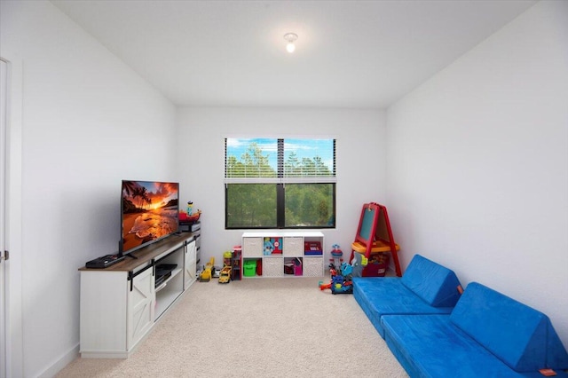recreation room featuring light colored carpet