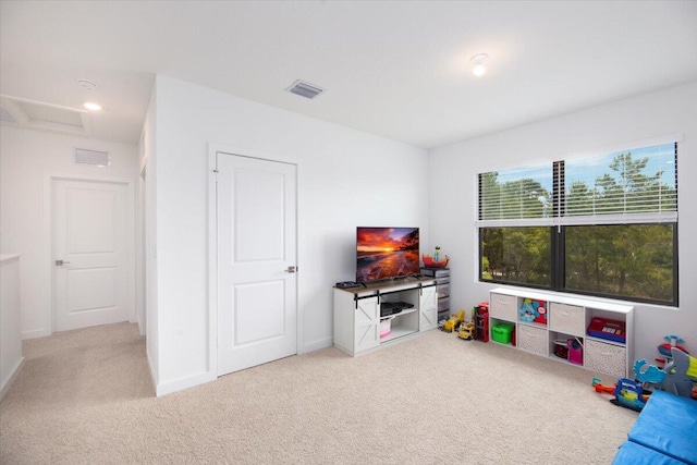 rec room featuring baseboards, carpet flooring, attic access, and visible vents