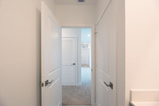 corridor featuring visible vents and carpet