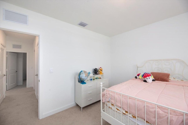 bedroom featuring baseboards, visible vents, and light carpet