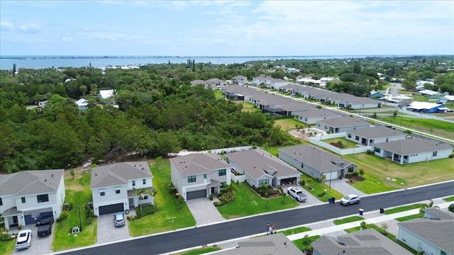 drone / aerial view with a water view and a residential view