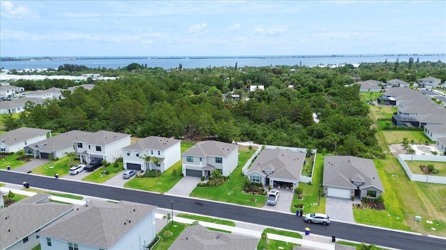 drone / aerial view with a residential view and a water view