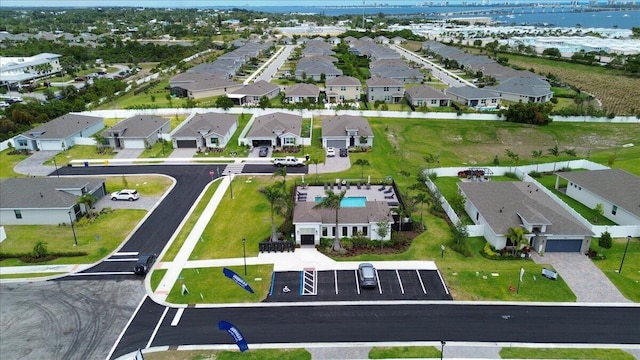 birds eye view of property featuring a water view and a residential view