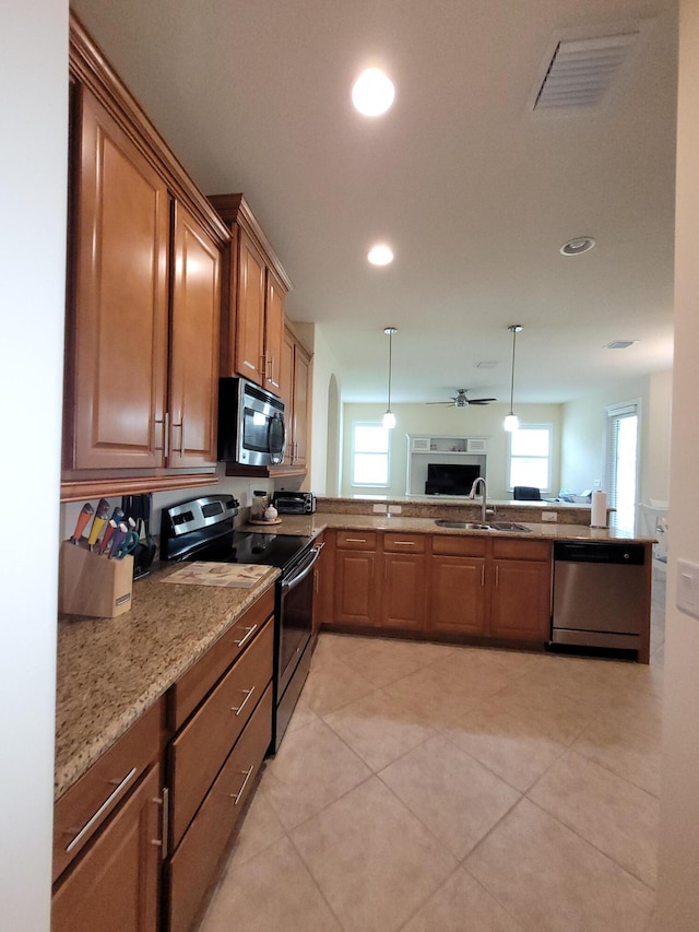 kitchen featuring a sink, a healthy amount of sunlight, stainless steel appliances, and open floor plan