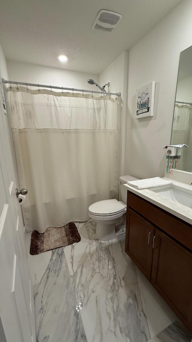 1372 SW Badcock Ave, Port Saint Lucie, FL 34953 - full bathroom with vanity, toilet, marble finish floors, a shower with curtain, and a textured ceiling