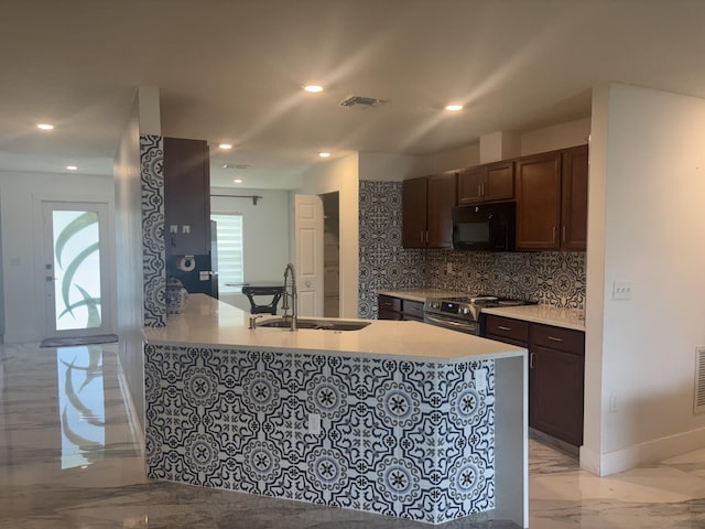 1372 SW Babcock Ave, Port Saint Lucie, FL 34953 - kitchen featuring black microwave, light marble finish flooring, stainless steel range, tasteful backsplash, and light countertops