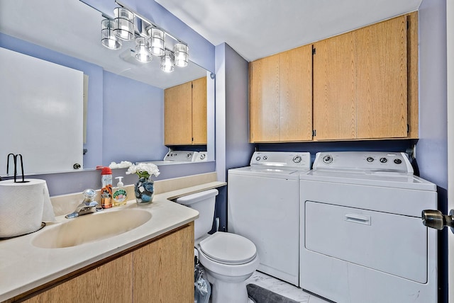 bathroom featuring separate washer and dryer, vanity, and toilet