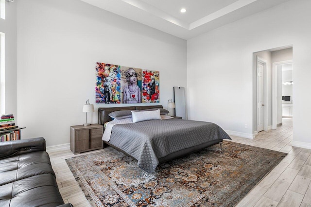 bedroom featuring baseboards, recessed lighting, and wood finished floors