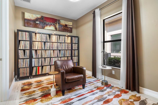 sitting room with baseboards and visible vents