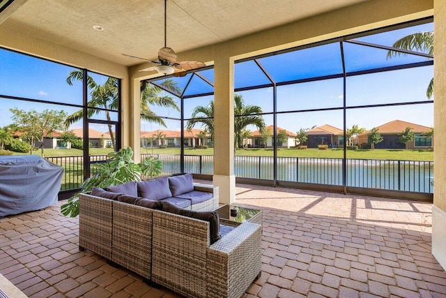 view of patio / terrace with a lanai, a water view, outdoor lounge area, and a residential view