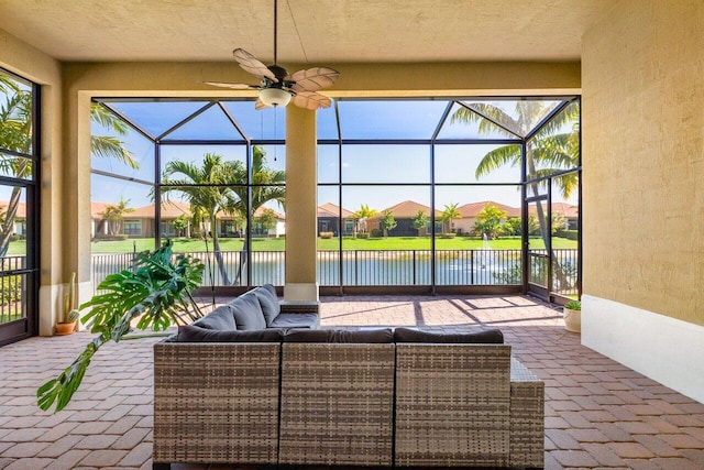 view of patio / terrace featuring an outdoor hangout area, a lanai, a water view, and ceiling fan