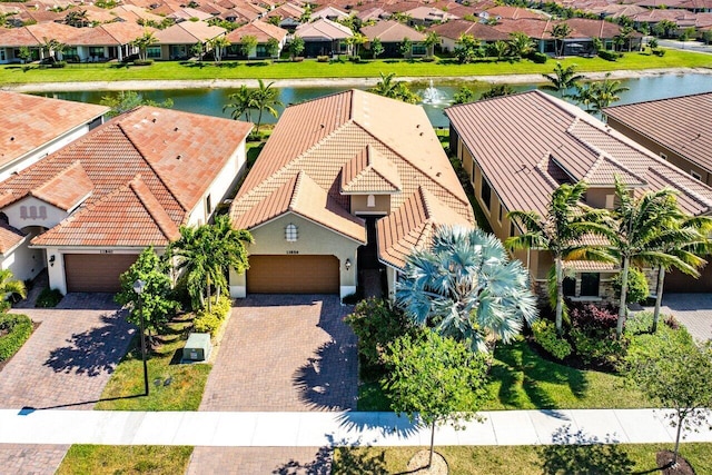 birds eye view of property featuring a water view and a residential view