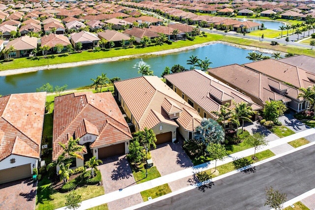 birds eye view of property featuring a water view and a residential view