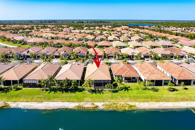 bird's eye view featuring a water view and a residential view