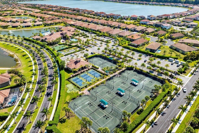 drone / aerial view with a water view and a residential view